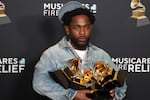 Kendrick Lamar with his five Grammy trophies.