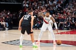 Portland Trail Blazers guard Damian Lillard motions to his teammates as Phoenix Suns guard Collin Gillespie defends.