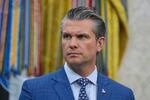 Defense Secretary Pete Hegseth is pictured with a serious facial expression while listening during an event with President Donald Trump to sign executive orders regarding nuclear energy in the Oval Office of the White House, Friday, May 23, 2025, in Washington. Only Hegseth is pictured. He's wearing a blue suit and dark-patterned tie.