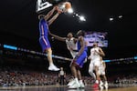 Alex Condon #21 of the Florida Gators dunks the ball against Joseph Tugler #11 of the Houston Cougars during the second half in the National Championship of the NCAA Men's Basketball Tournament at the Alamodome on Monday in San Antonio, Texas. Florida defeated Houston to win its third title.
