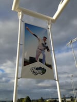 A Hillsboro Hops banner is displayed outside the stadium before the home opener.