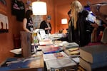 Attendees of the Booklover's Burlesque Festival at Portland's Alberta Rose Theater browse books for sale before Saturday night's performances.