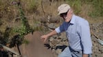 Paul Fishman points out one of the rusty World War II ship scraps still left on the bank of Portland’s Willamette River.