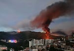 Fire at Fuerte Tiuna, Venezuela's largest military complex, is seen from a distance after a series of explosions in Caracas on January 3, 2026.