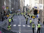 Police officers wait for Queen Elizabeth II's coffin on the Royal Mile in Edinburgh.