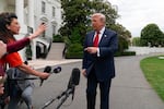 President Donald Trump speaks to reporters as he walks to board Marine One on the South Lawn of the White House, Friday, May 8, 2026, in Washington.
