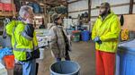 Three people, Washington state Sen. Jeff Wilson and U.S. Representative Marie Gluesenkamp Perez talk with commercial fisherman Jay Vaughn in Ilwaco about the impacts of a Jan. 22 seafood facility fire on local fishermen.