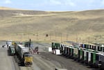 In this Aug. 3, 2004, file photo, garbage, hauled in by train, is unloaded onto trucks for transfer to the Arlington, Ore., landfill.