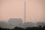 Hazy skies caused by Canadian wildfires blanket the monuments and skyline of Washington, D.C. on June 7, 2023 as seen from Arlington, Virginia. The Washington DC area is under a Code Orange air quality alert indicating unhealthy air for some members of the general public.