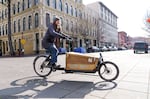 Diana Rempe rides the Street Books library bike, traveling to another library site. Street Books is a mobile library that serves people experiencing homelessness. Books are free to check out, and no ID is required.