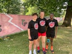 Members of the Cherry Bombs FC, a pre-professional soccer team that debuted this year, pose for a portrait after practice on June 23, 2026, at Lents Park in Portland, Ore. From left: defender Torie Snyder, goalkeeper Emma Cameron and forward Oluwatomisin Eludipo.