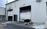 Two large metal shop garage doors with smoke damage