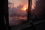 Thurs., Jan. 9: Debris covers the ground after the Palisades Fire ravaged a neighborhood amid high winds in the Pacific Palisades neighborhood of Los Angeles, Thursday, Jan. 9, 2025. (AP Photo/Damian Dovarganes)