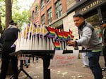 A soccer fan takes a pride flag moments before the FIFA World Cup match between Egypt and Iran on Friday, June 26, 2026, at Occidental Square in Seattle's Pioneer Square neighborhood.