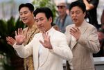 Lee Sun-kyun, center, Ju Ji-hoon and Kim Hee-won pose for photographers at the photo call for the film 'Project Silence' at the 76th international film festival, Cannes, southern France, Monday, May 22, 2023.