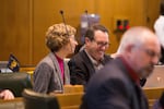 Rep. Paul Holvey, D-Eugene, (right) speaks with Rep. Nancy Nathanson, D-Eugene, in the House Chamber on April 30, 2019, in Salem, Ore.