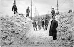 Road crew with shovels stand on foster road after clearing snow off street during 1916 winter snowfall, Foster Road in SE Portland, Jan. 21. 1916.
