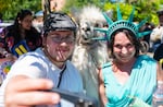 Attendees of the Portland Pride parade take a photo with Caesar the No Drama Llama at the end of the parade route.

