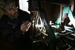 John Pohlpeter sets the time on the mechanism for the clock at Union Station in Portland on March 9, 2024. Twice a year, he changes the time on the clock for daylight saving time.