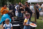 People collect their meals at the Labor Day picnic.
