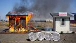 At a demonstration in California, fire experts show how bark mulch can act like matches. A stone walkway directly next to a building can prevent a wildfire from burning it down.