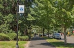 People walk along the mixed-use path bordering Interstate 205 inside the city of Maywood Park, Ore., on Saturday, July 20, 2019.