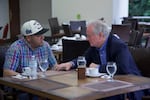 Kilmar Abrego Garcia, a Salvadoran citizen who was deported to El Salvador by the Trump administration, speaks with Sen. Chris Van Hollen, D-Md., in a hotel restaurant in San Salvador on April 17.