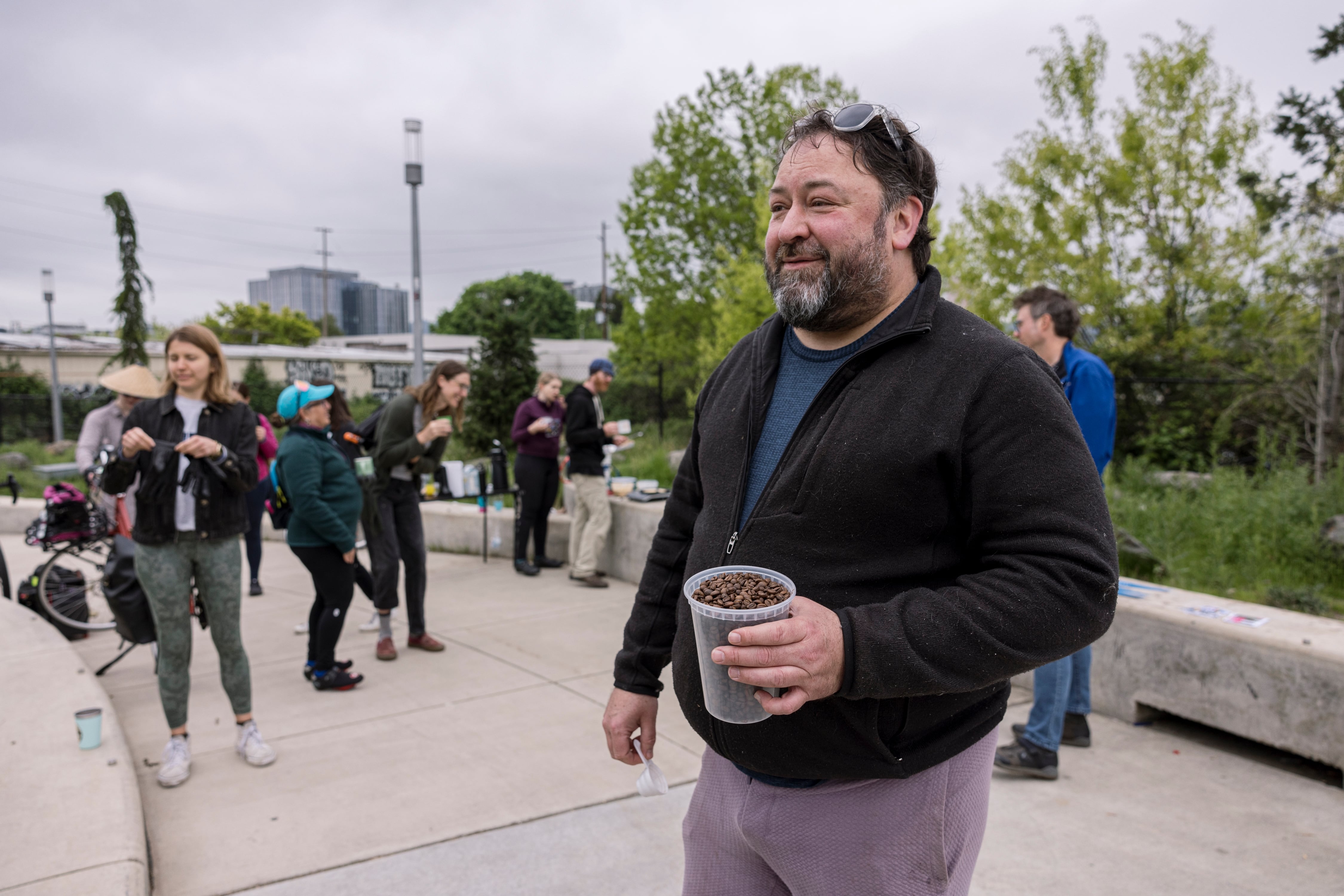 Andrew Kreps, one of the organizers for the Blumenauer Bridge breakfast, holds coffee beans he roasted himself.