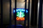 A dispensary sign glows in the windows of Bridge City Collective in Portland, Ore., on Jan. 6, 2026.