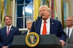 President Donald Trump speaks in the Oval Office of the White House, Friday, Oct. 10, 2025, in Washington, as Virginia Gov. Glenn Youngkin, Centers for Medicare & Medicaid Services administrator Dr. Mehmet Oz and Health and Human Services Secretary Robert F. Kennedy Jr., listen.