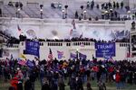 FILE - In this Jan. 6, 2021, file photo violent rioters, loyal to President Donald Trump, storm the Capitol in Washington. The words of Donald Trump supporters who are accused of participating in the deadly U.S. Capitol riot may end up being used against him in his Senate impeachment trial as he faces the charge of inciting a violent insurrection. (AP Photo/John Minchillo, File)