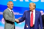 President-elect Donald Trump shakes hands with Robert F. Kennedy Jr., at a campaign rally in October. Kennedy, who is skeptical of vaccines, is among Trump's advisors on health.