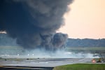 Fire and smoke mark the spot where UPS Flight 2976 crashed shortly after takeoff near Louisville Muhammad Ali International Airport in Louisville, Kentucky.