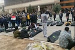 FILE - This image from video taken between Jan. 9 and Jan. 11, 2026, and verified by AP, shows mourners next to the bodies of people who were brought from different locations, outside a morgue in Kahrizak, in Iran's Tehran province, after a crackdown on protests.