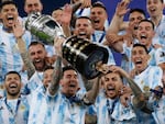 Argentina's Lionel Messi celebrates with the trophy after beating Brazil 1-0 in the Copa America final soccer match at Maracana stadium in Rio de Janeiro, Brazil, Saturday, July 10, 2021. Messi and Argentina will try to win their third straight major title when they defend their Copa America championship while Brazil hopes 17-year-old Endrick will combine with Vinícius Júnior and Rodrygo for success. (AP Photo/Bruna Prado, File)