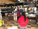 Customers line up in Calderón's shop on a recent Saturday morning. Calderón knows the struggles of his clientele well because he used to be a farmworker.