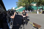 A reporter records a segment at the Douglas County Fairgrounds, where Umpqua Community College students and faculty members were evacuated to following a shooting on campus Thursday.