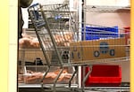 A patron pushes a shopping cart at the Packed with Pride pantry in Tigard, Ore., on Nov. 6, 2025. Staff at the pantry say despite SNAP being restored, they're still busy.