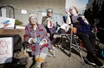 (From left to right) Tracy Wright, 67, Beth Kent, 75, and Kathryn Gearheard, 78, protesting outside the U.S. Immigration and Customs Enforcement facility in South Portland, Oct. 23, 2025. Their group, Knitters Against Fascism, protests weekly in the mornings across the street from the facility.