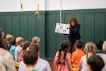 Portland children's book author and illustrator Zoey Abbott reads one of her books to preschool students in the gym at the Sellwood Community House in Portland, Ore., on May 15, 2026. The former public community center that nearly closed in 2019 is now run by the Sellwood Community House nonprofit.