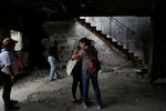 People hug at the house of Maayan and Yuval Bar killed by Hamas, as Israel marks the one-year anniversary of the Hamas attack on Israel, at the Kibbutz Be'eri, an Israeli communal farm on the Gaza border on Monday.