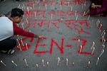 People light candles beside the words reading "Long live martyrs" during a silent tribute observing a national day of mourning in honor of those killed in clashes during recent protests, in Kathmandu, Nepal, on Wednesday.
