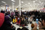 Community members and neighbors of people detained by ICE gather in protest at a Target store, on Jan. 19, 2026, in St. Paul, Minn.