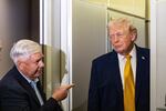 FILE - Sen. Lindsey Graham, R-S.C., left, gestures as President Donald Trump speaks with reporters while in flight on Air Force One, Jan. 4, 2026, as they were returning to Joint Base Andrews, Md.