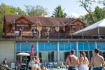 Guests look out from a newly renovated deck out toward the mountains and friends and family enjoying the pool.