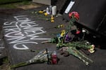 Flowers and chalk spelling out “Longview Strong” mark a makeshift memorial on old mill equipment in front of Nippon Dynawave Packaging Co. for victims of the May 26 chemical disaster in Longview, Wash., on May 29, 2026.