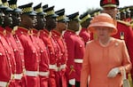 Troops parade for Queen Elizabeth II as she arrives in Kingston, Jamaica, in 2002.