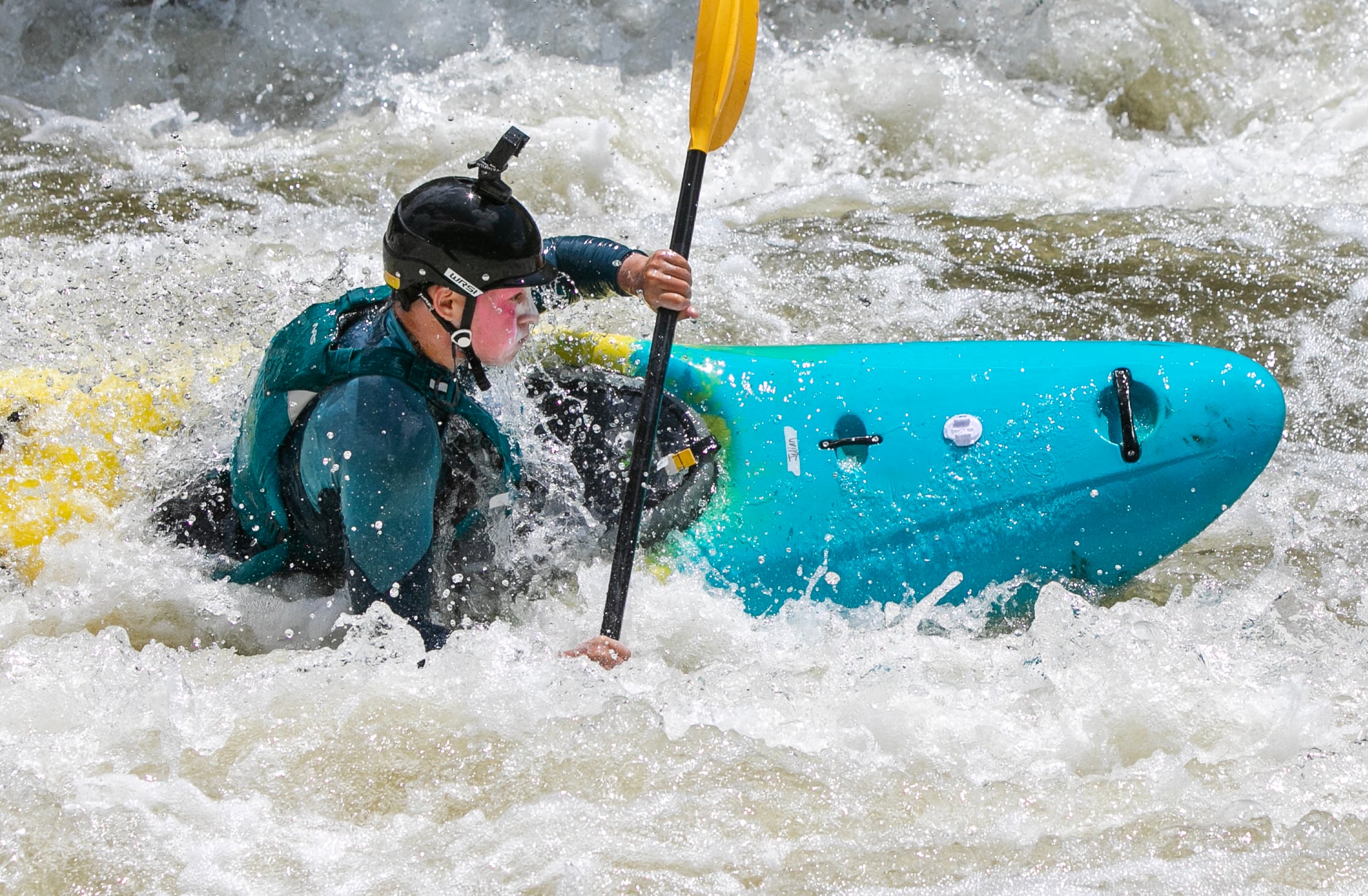 Hoopa Valley Tribal member Julian To:Nikya:w Rogers, 16, paddles through a rapid in Kikacéki Canyon on the Klamath River, June 22, 2025.