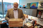 Omer Mozaffar, Loyola University Chicago's Muslim chaplain, holds boxes of dates in his office. Dates are typically eaten to break the fast during Ramadan.
