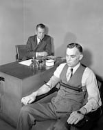 Leonarde Keeler, 48, who helped develop the science of lie detection, conducts a polygraph test on April 13, 1948. (AP Photo/Edward Kitch)